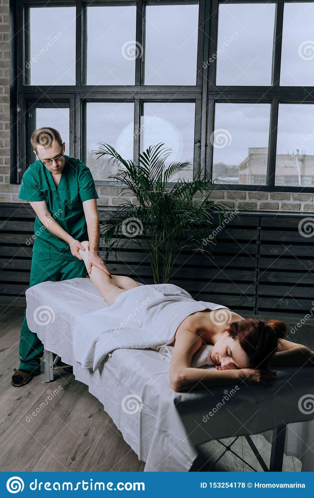 A Male Massage Therapist Massages A Young Woman, A Method ...