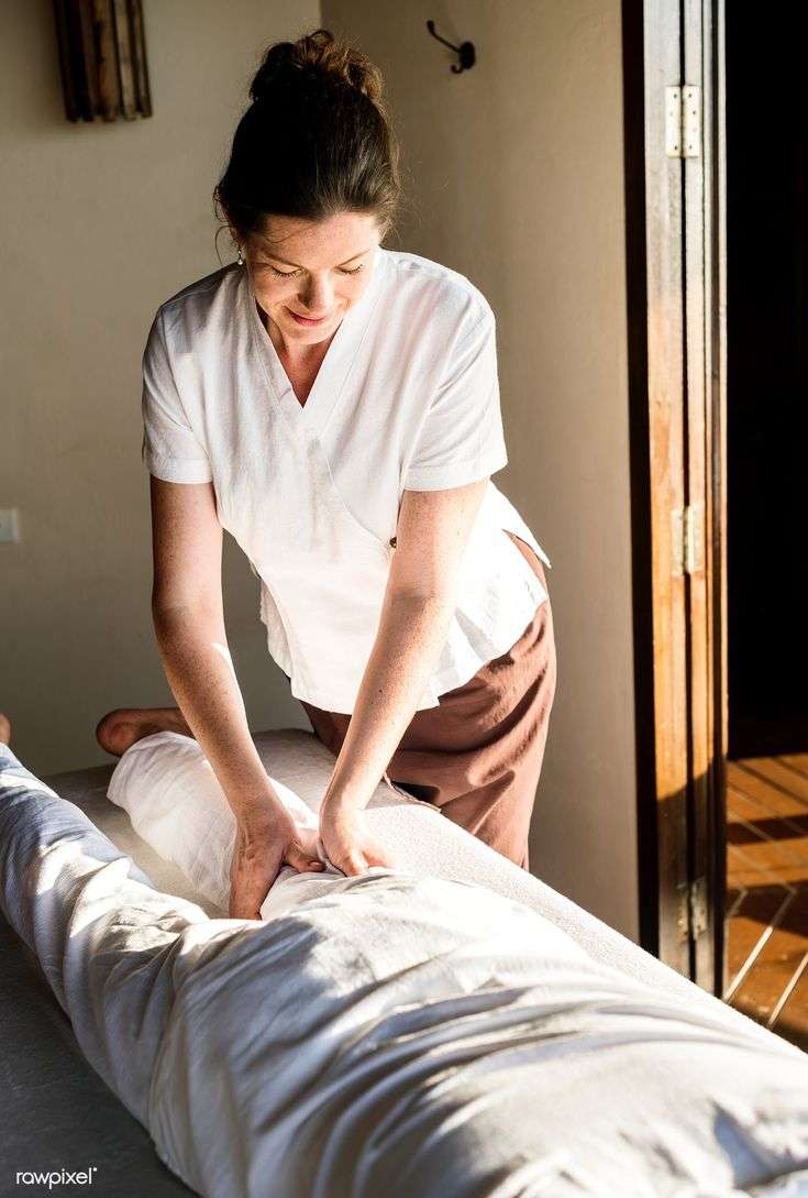 Download premium image of Female massage therapist giving ...