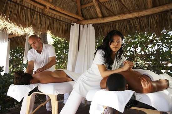 Outdoor couples massage under one of our cabanas