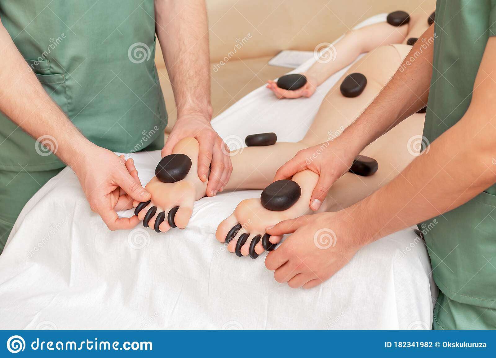 Stones Massage On Legs Of Woman Stock Photo